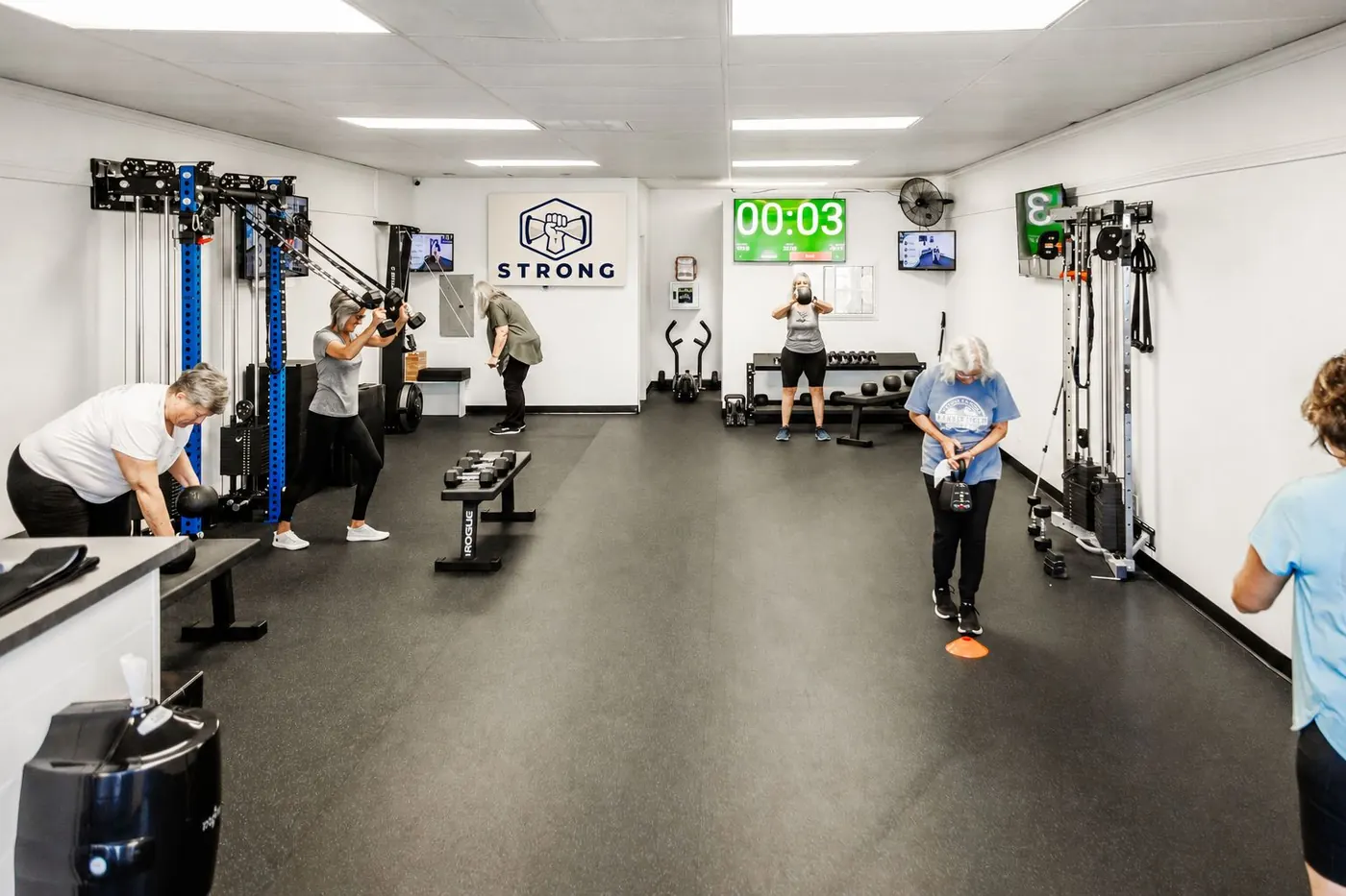 Members training at stations during a STRONG Circuit session