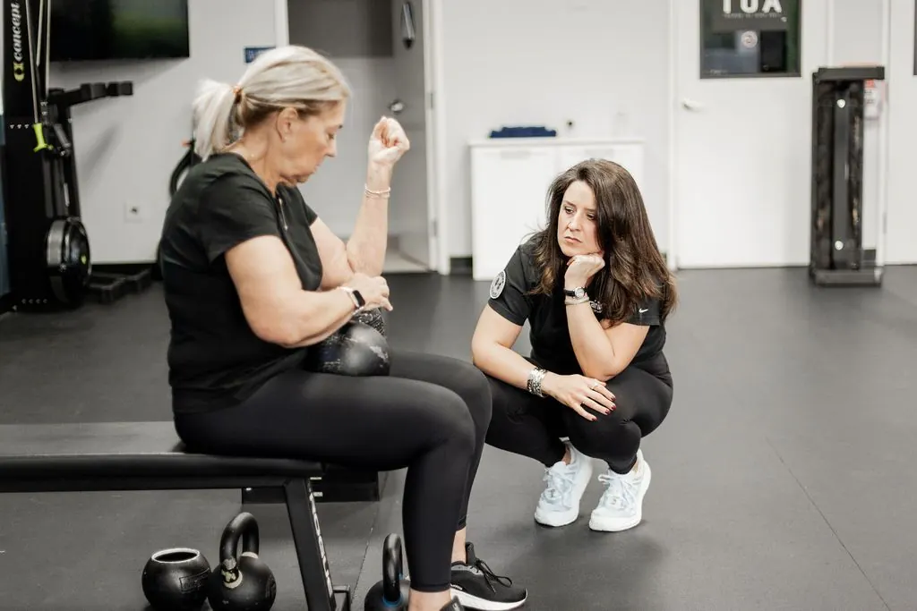 A coach working one-on-one with a member